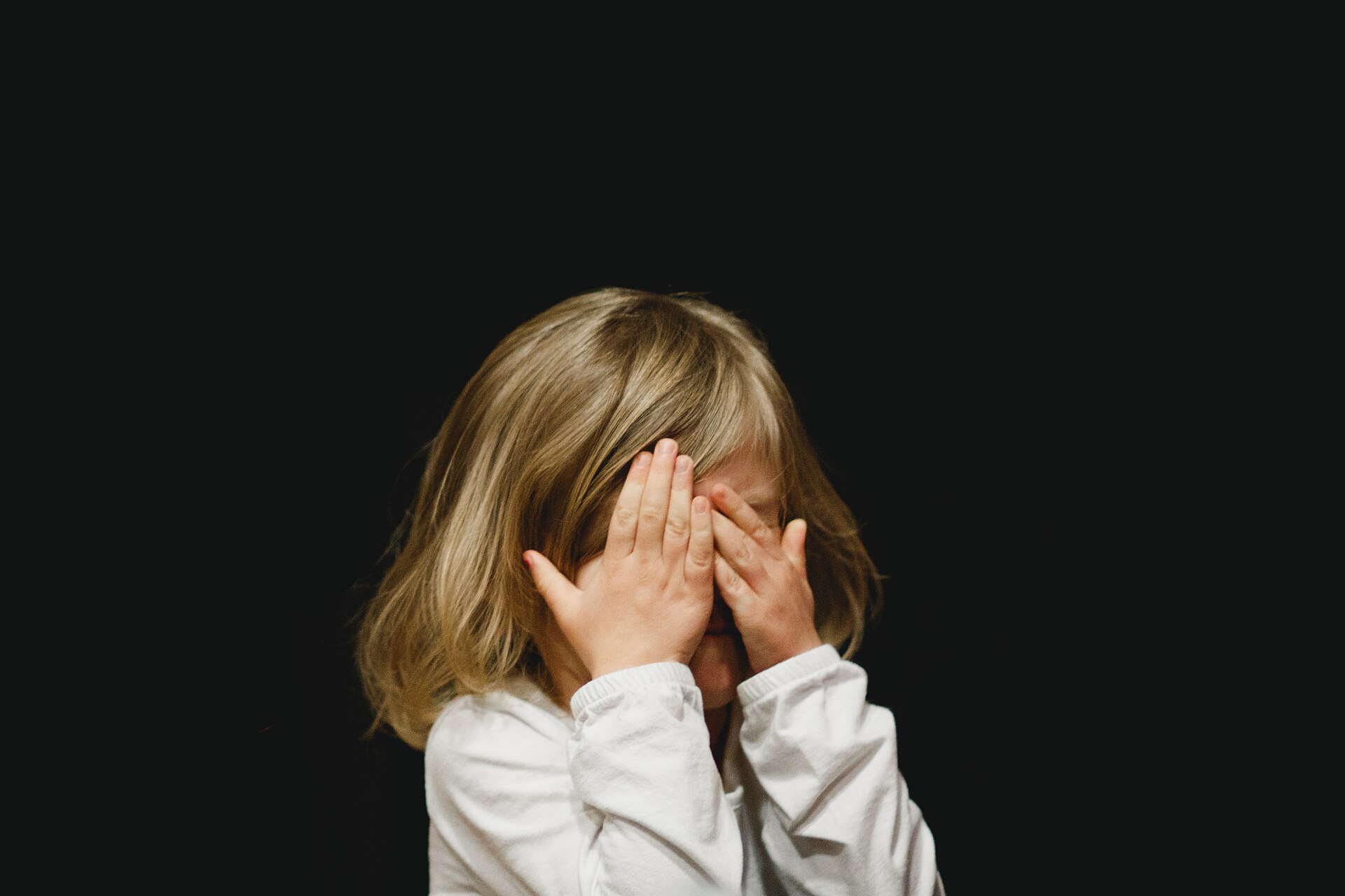 hands covering face